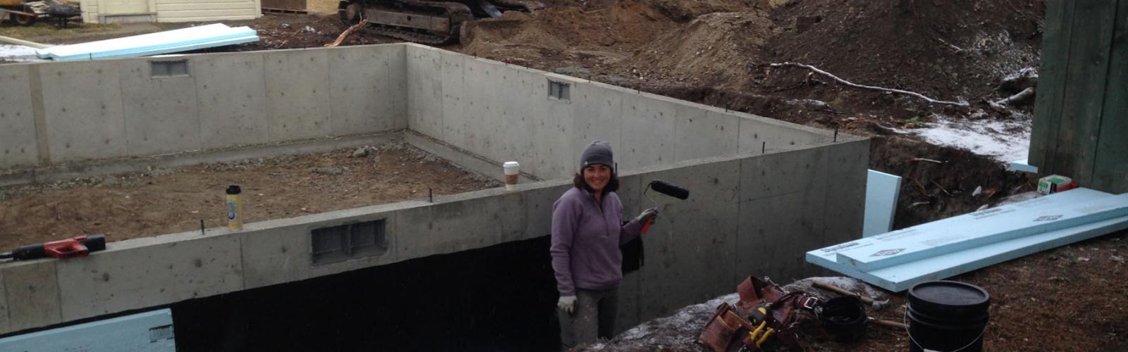applying foundation coating on walls to damp proof