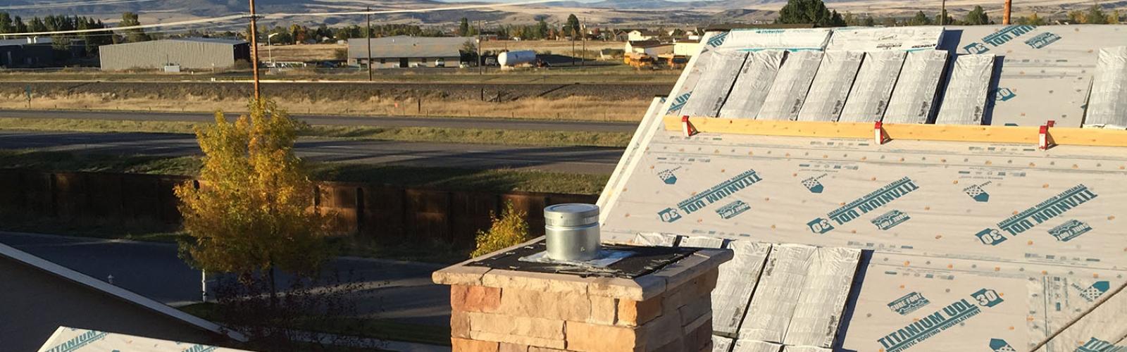 roof stocked with shingles, masonry on chimney